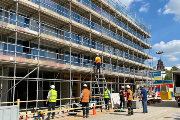 Commercial scaffolding in action during building renovation in London, showcasing professional construction safety practices and teamwork.
